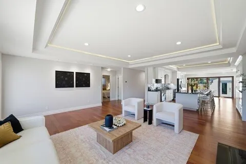 a kitchen with stainless steel appliances kitchen island granite countertop a refrigerator and a stove top oven