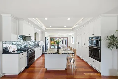 a kitchen with stainless steel appliances a sink stove and cabinets