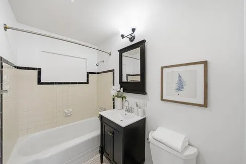 a bedroom with a bed and a potted plant