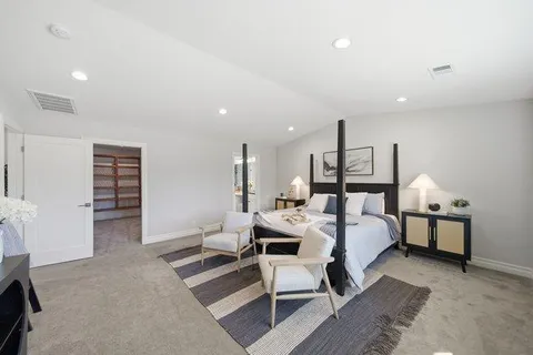 a bedroom with a bed and a table