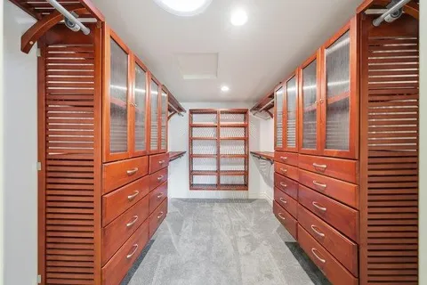 a bedroom with a bed and a view of kitchen