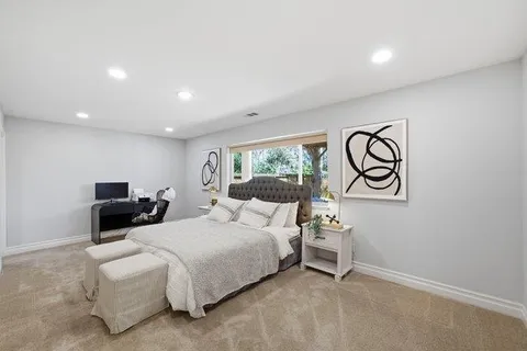 a view of a house with backyard and sitting area