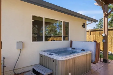 a backyard of a house with table and chairs