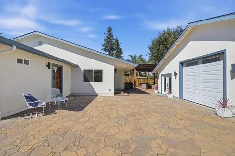 an aerial view of a house with pool table and chairs