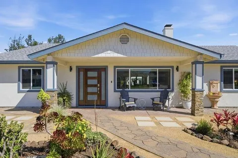 a living room with furniture a fireplace and a large window