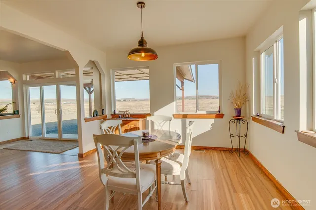a dining room with furniture a chandelier and wooden floor