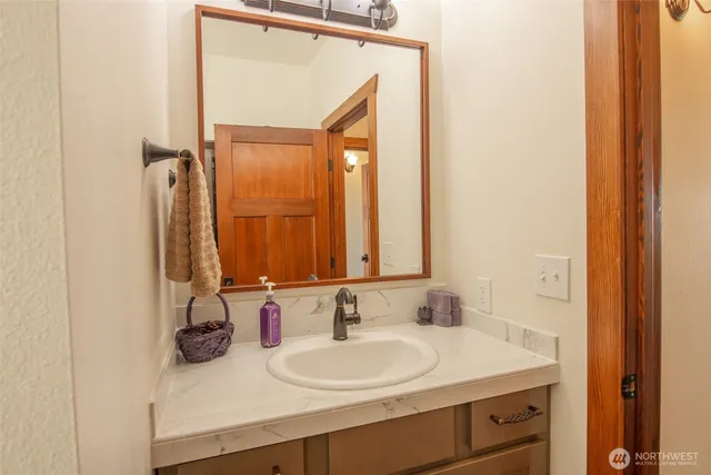 a bathroom with a sink a toilet and a window