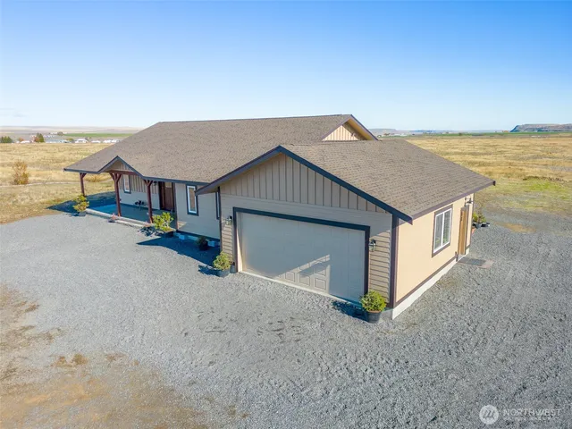 a building outdoor space with patio furniture and garden