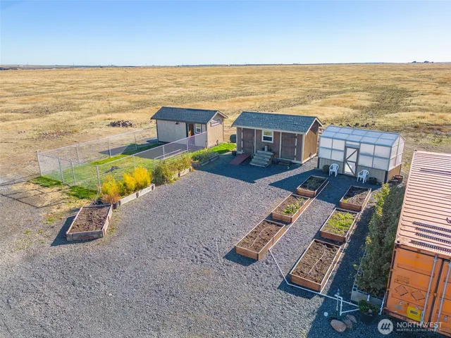a view of a kitchen with wooden floor and electronic appliances