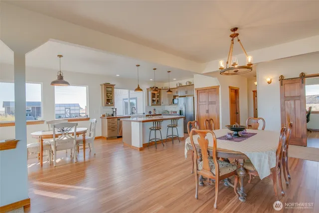 a large kitchen with stainless steel appliances a large center island attached withe living room