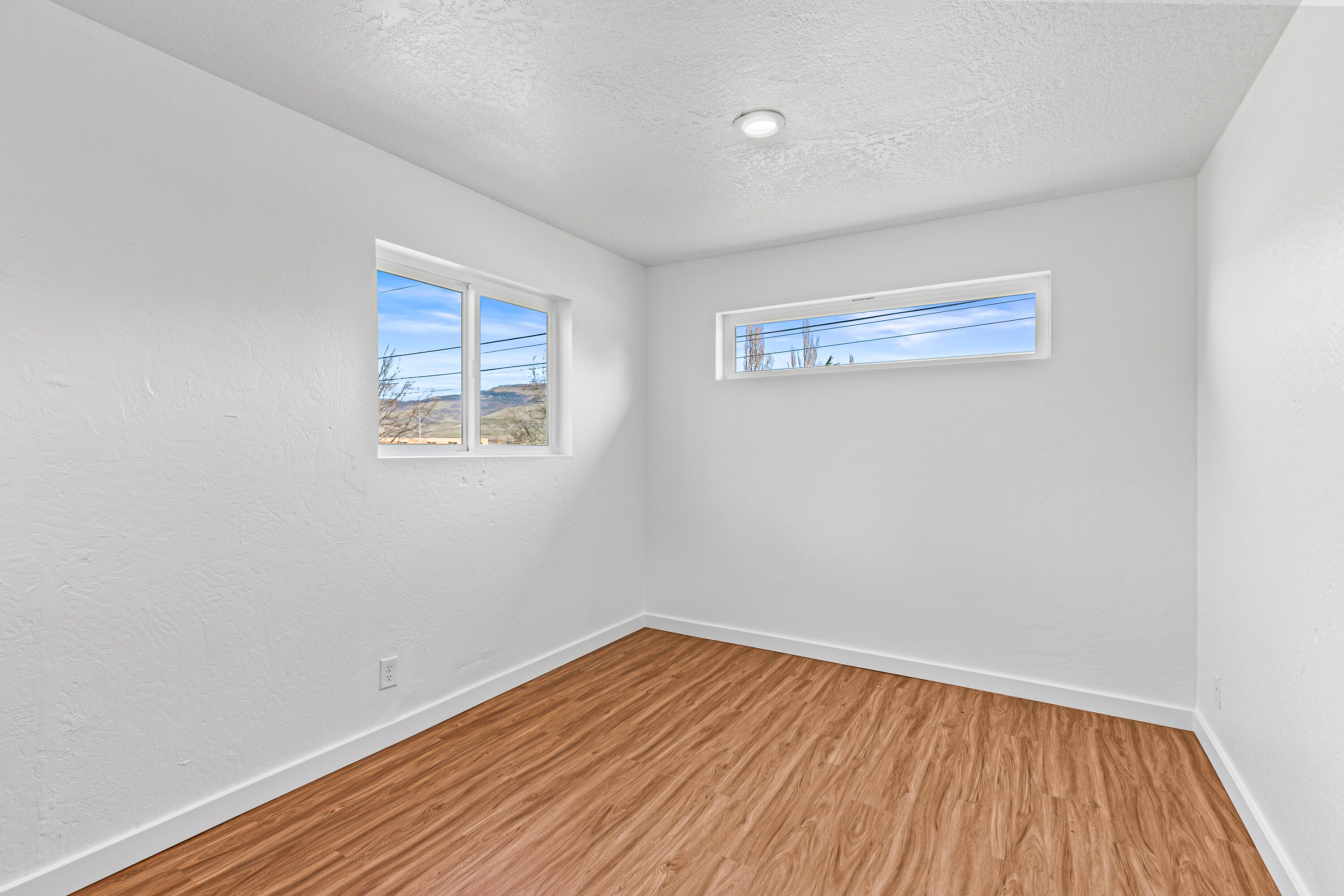 593 Crowson Road Ashland, OR 97520 - Photo 30 of 36 a view of a room with wooden floor and white walls