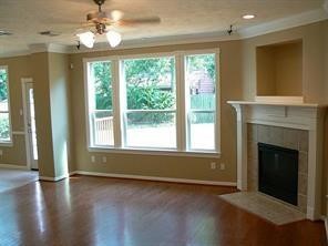 951 Lamonte Lane Houston, TX 77018 - Photo 6 of 26 a view of an empty room with wooden floor and a window