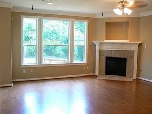 951 Lamonte Lane Houston, TX 77018 - Photo 7 of 26 wooden floor fireplace and windows in an empty room