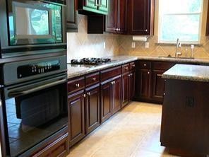 951 Lamonte Lane Houston, TX 77018 - Photo 9 of 26 a kitchen with granite countertop a stove and a sink