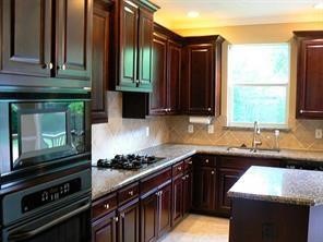 951 Lamonte Lane Houston, TX 77018 - Photo 10 of 26 a kitchen with a sink stove top oven and cabinets