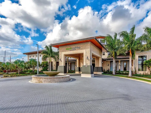 a view of a yard with cars park