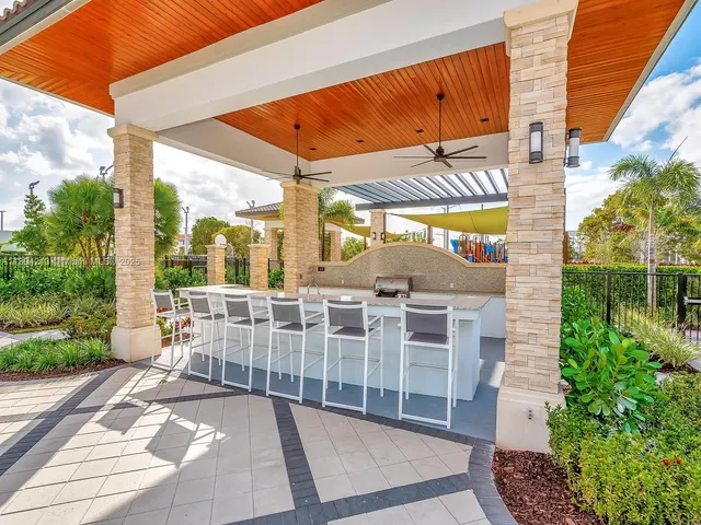 a view of a tennis ground with large trees