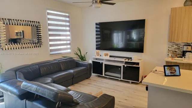 a kitchen with a sink a kitchen island and stainless steel appliances