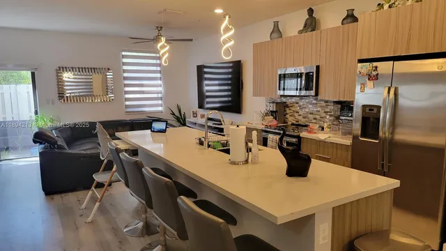 a white toilet sitting next to a shower