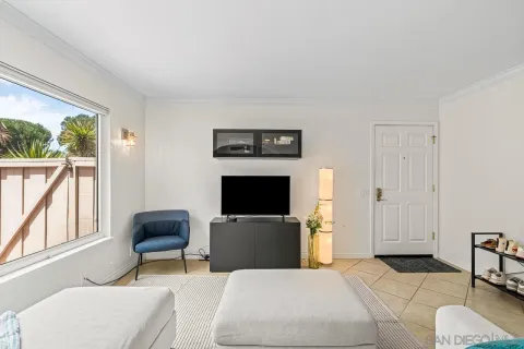 a bedroom with a bed and a television