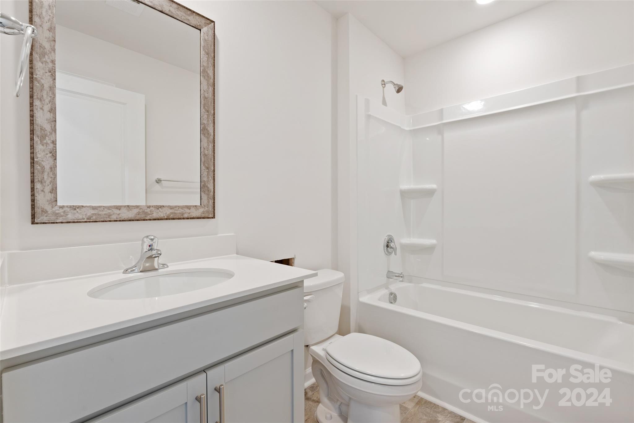 160 Callie River Clyde, NC 28721 - Photo 12 of 24 a bathroom with a sink a toilet and shower