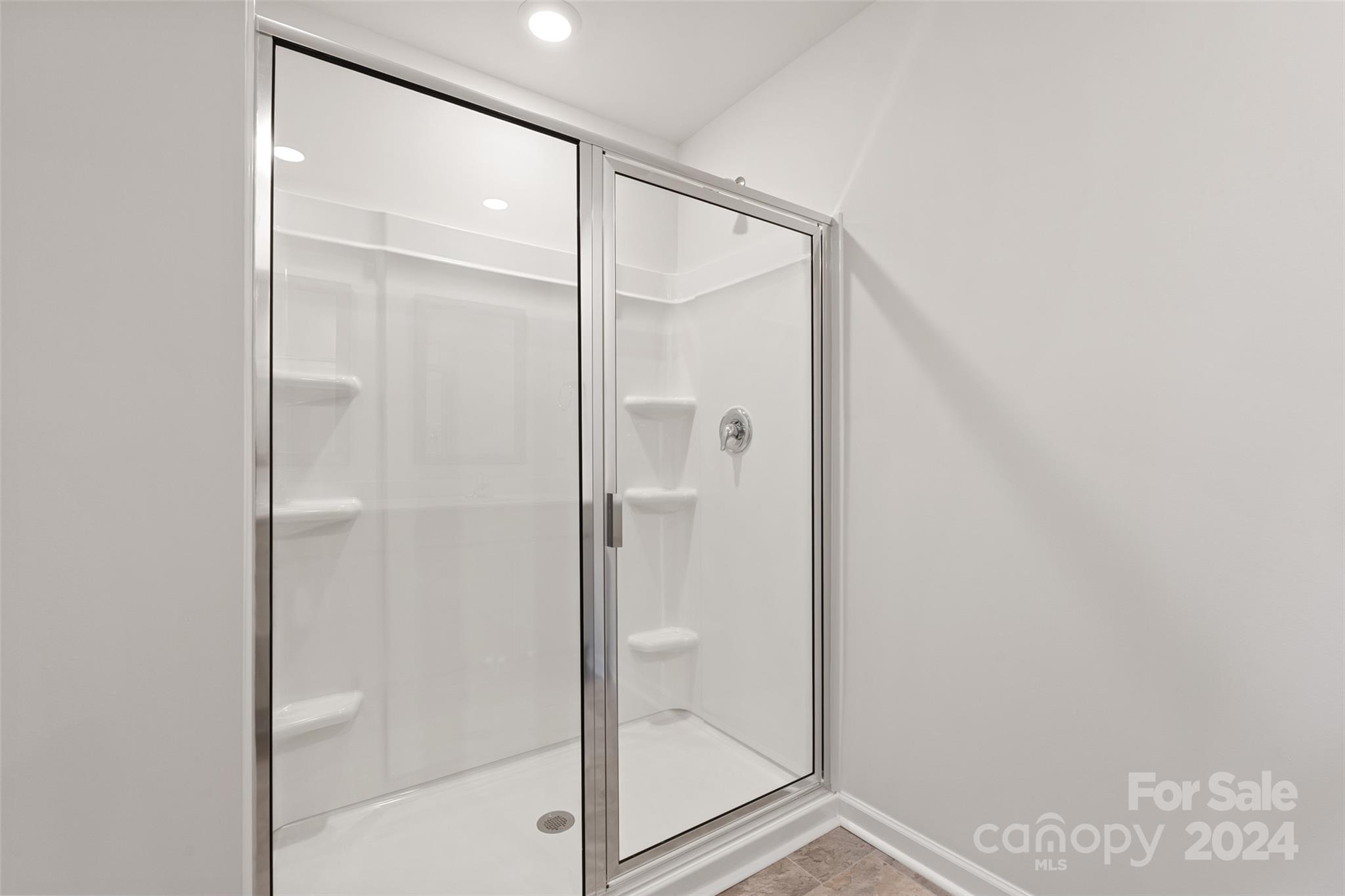 160 Callie River Clyde, NC 28721 - Photo 17 of 24 a bathroom with a glass shower door