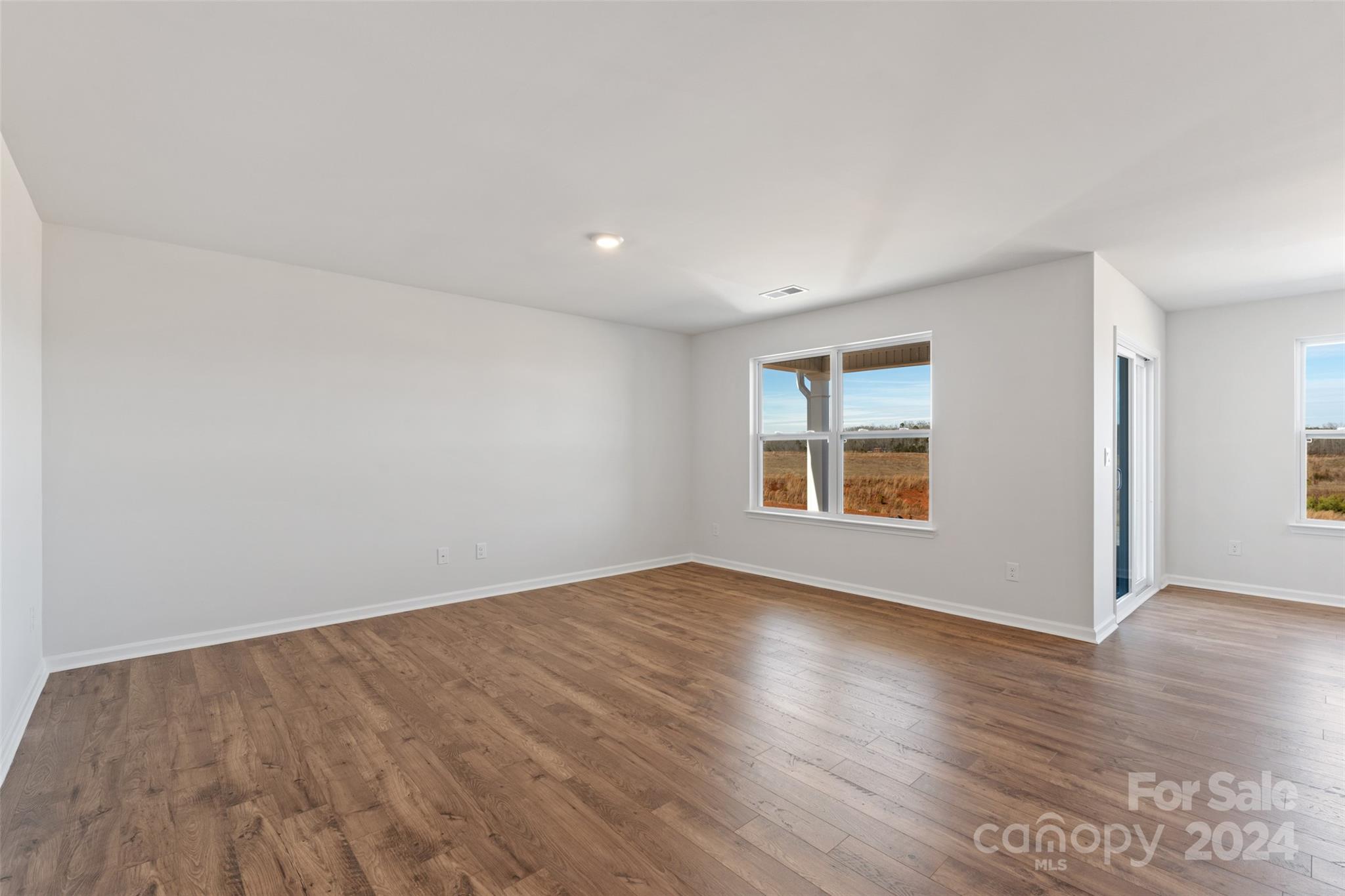 160 Callie River Clyde, NC 28721 - Photo 6 of 24 a view of an empty room with wooden floor and a window