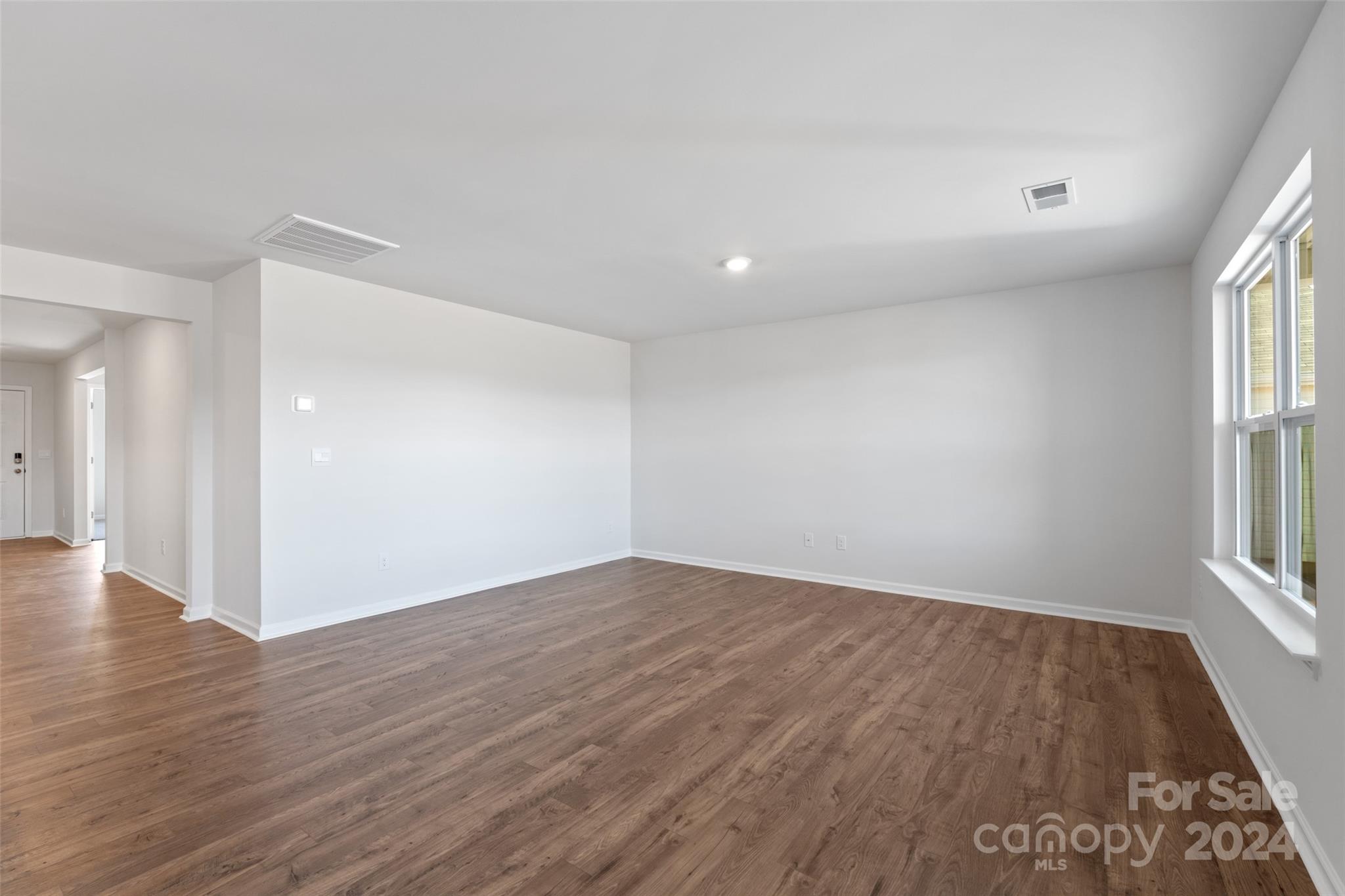160 Callie River Clyde, NC 28721 - Photo 8 of 24 wooden floor in an empty room with a window