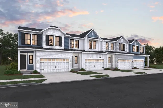 a view of multiple houses with a street