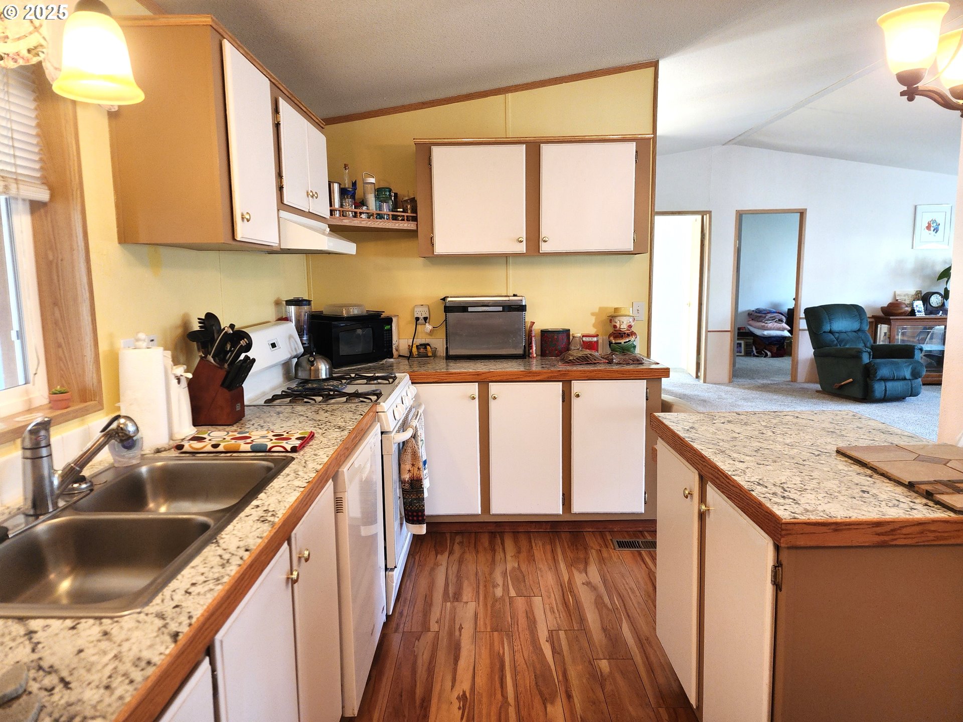 313 12th Street, Unit 4 La Grande, OR 97850 - Photo 14 of 32 a kitchen with granite countertop a sink a counter space appliances and cabinets