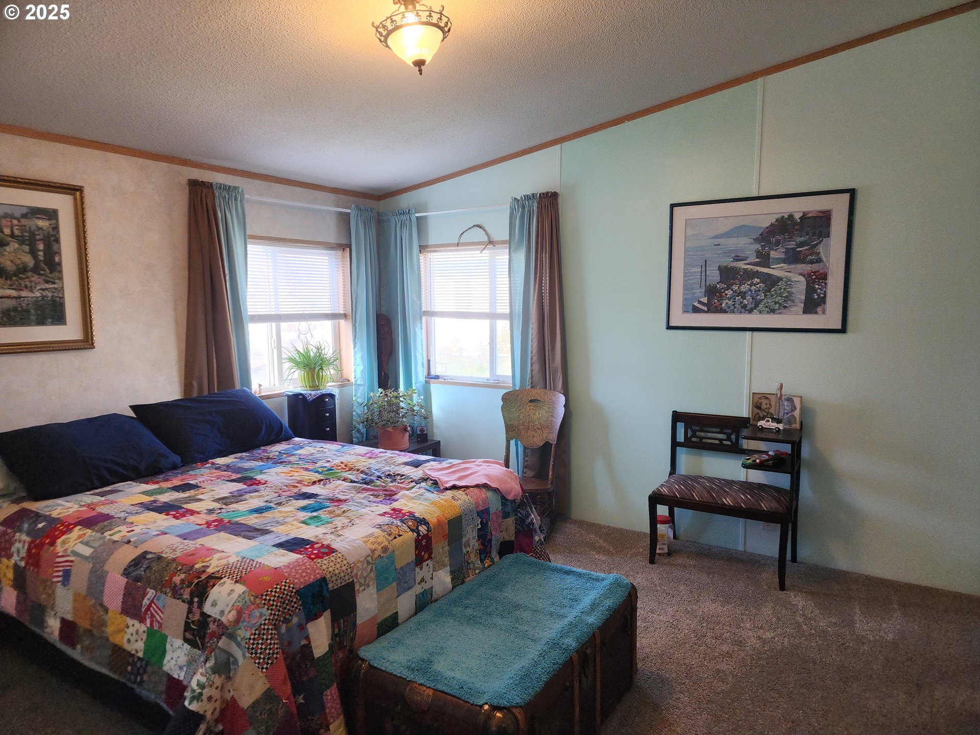 313 12th Street, Unit 4 La Grande, OR 97850 - Photo 18 of 32 a bedroom with a bed and a lounge chair