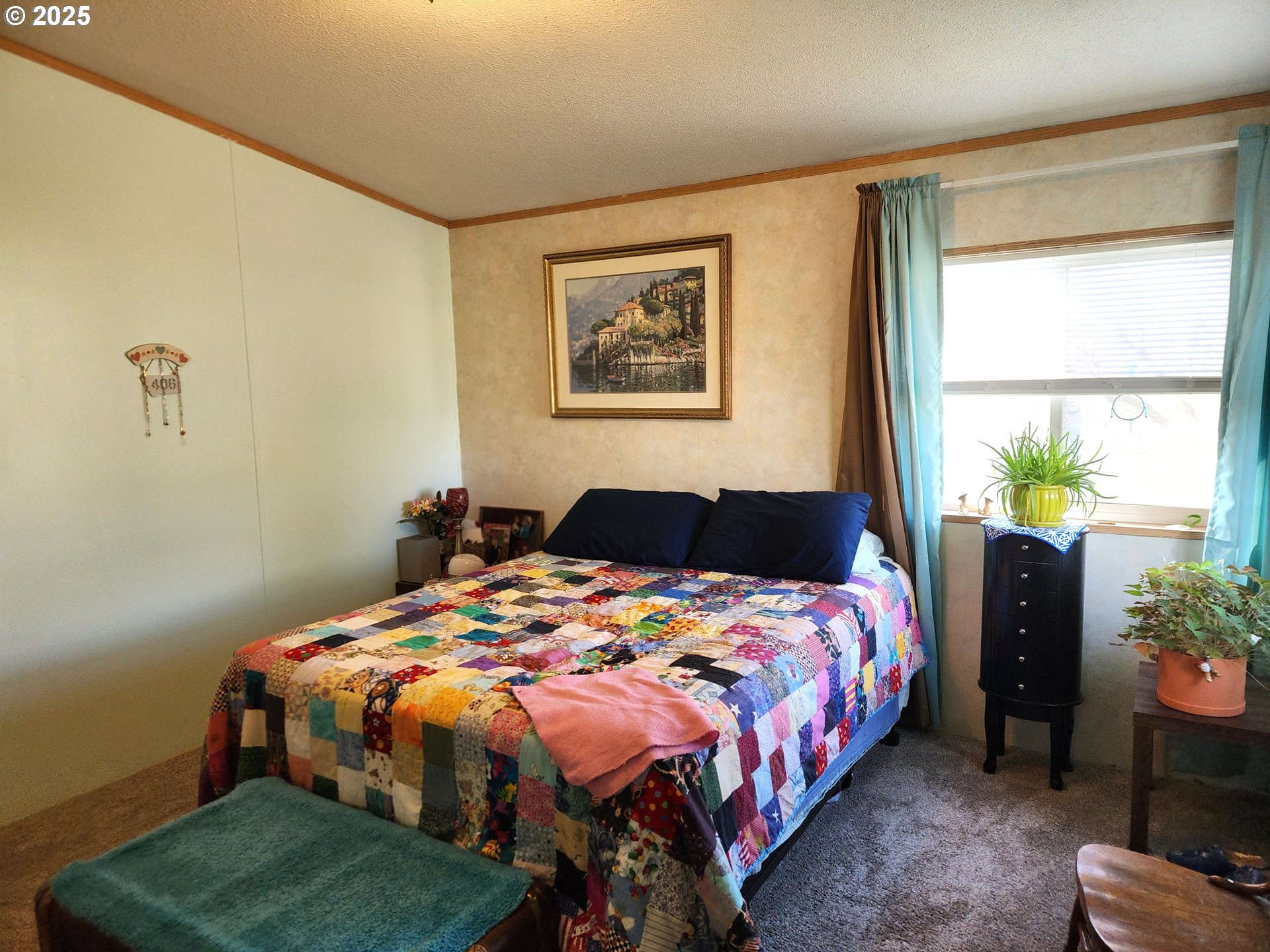 313 12th Street, Unit 4 La Grande, OR 97850 - Photo 19 of 32 a bed sitting in a bedroom next to a window