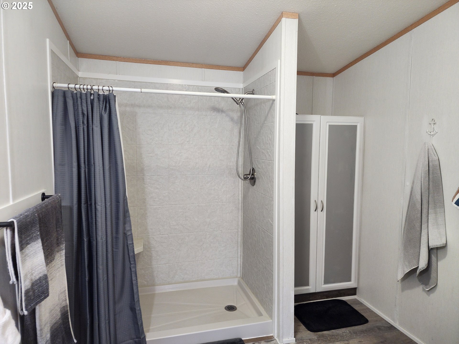 313 12th Street, Unit 4 La Grande, OR 97850 - Photo 20 of 32 a bathroom with a glass shower door