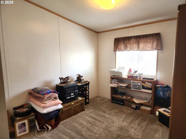 a very nice looking room with a book shelf and a window