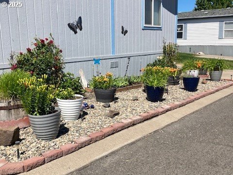 313 12th Street, Unit 4 La Grande, OR 97850 - Photo 32 of 32 a potted plant sitting on the side of a house