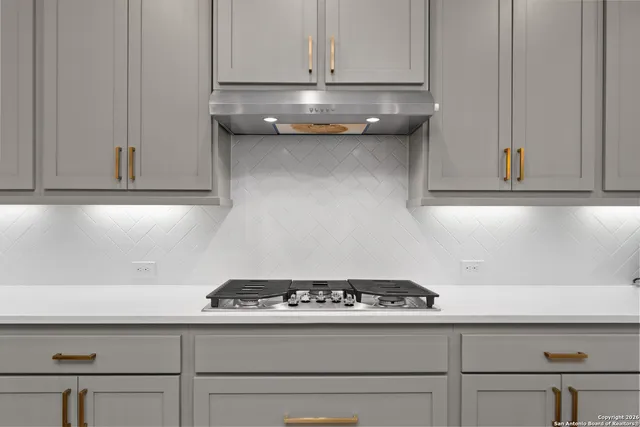 a stove top oven sitting inside of a kitchen