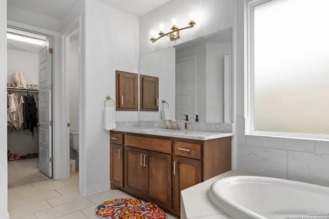 a bathroom with a sink a toilet and mirror