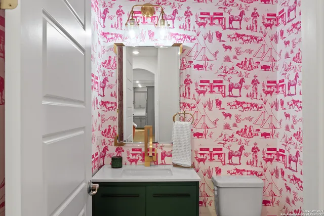 a bathroom with a sink mirror and vanity