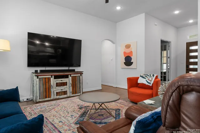 a living room with furniture and a flat screen tv