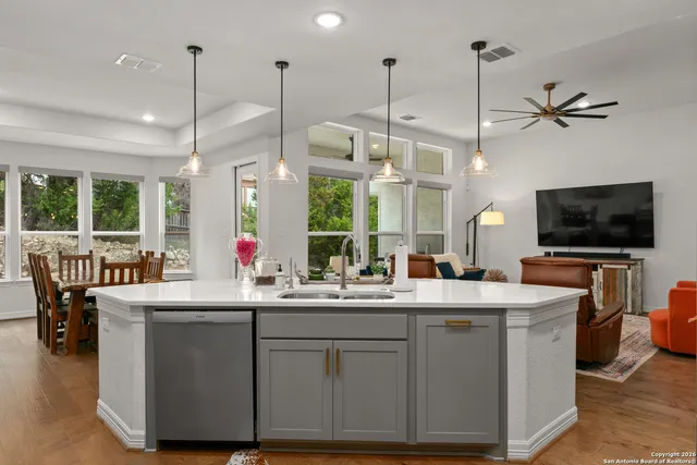 a kitchen with kitchen island a sink and a wooden floor