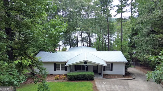 a aerial view of a house with yard and green space