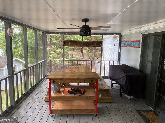 a living room with furniture and a floor to ceiling window