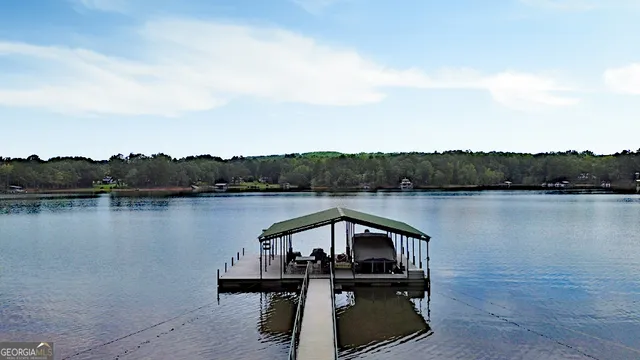 an aerial view of ocean and residential houses with outdoor space