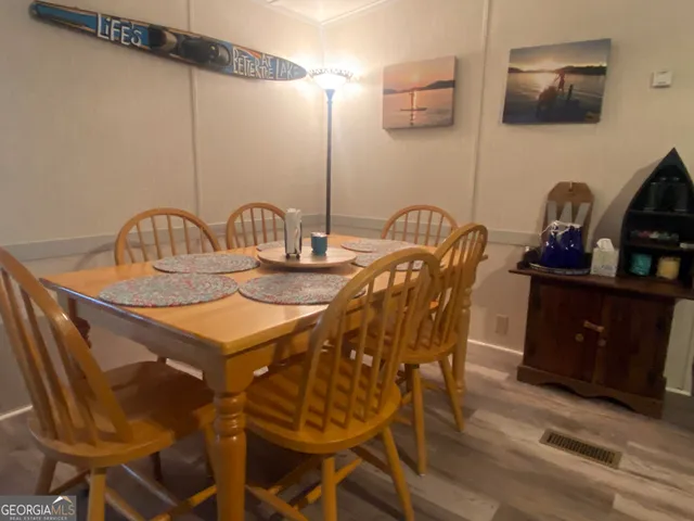 a dining room with furniture and wooden floor