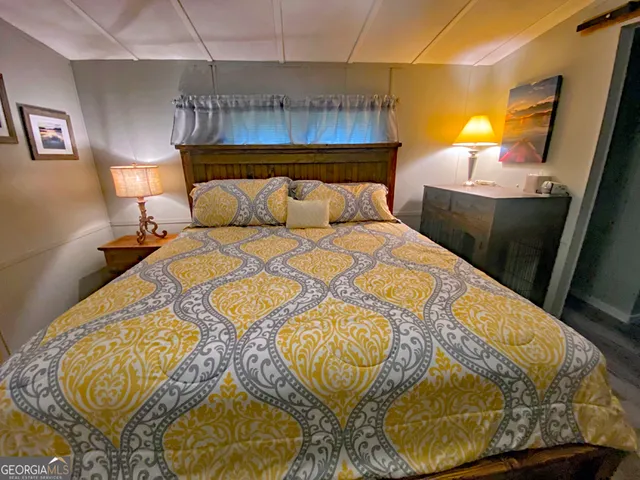 a bedroom with a bed and a mirror