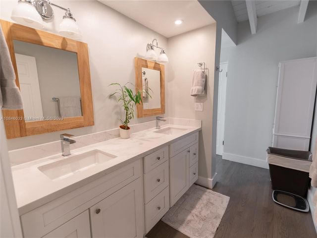 a bathroom with a double vanity sink and mirror