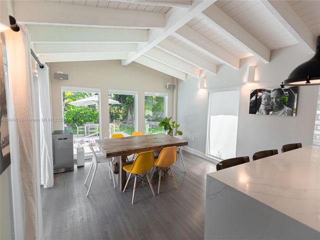 a dining room with furniture and wooden floor