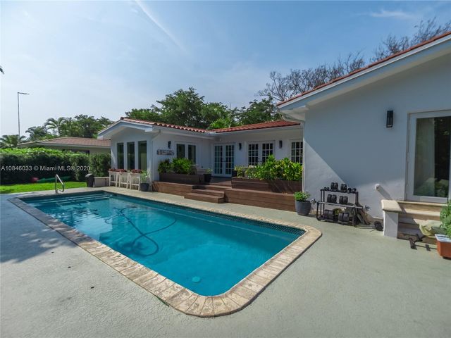 a view of a house with swimming pool and porch