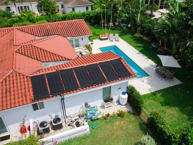 a view of a deck with couches table and chairs with wooden fence