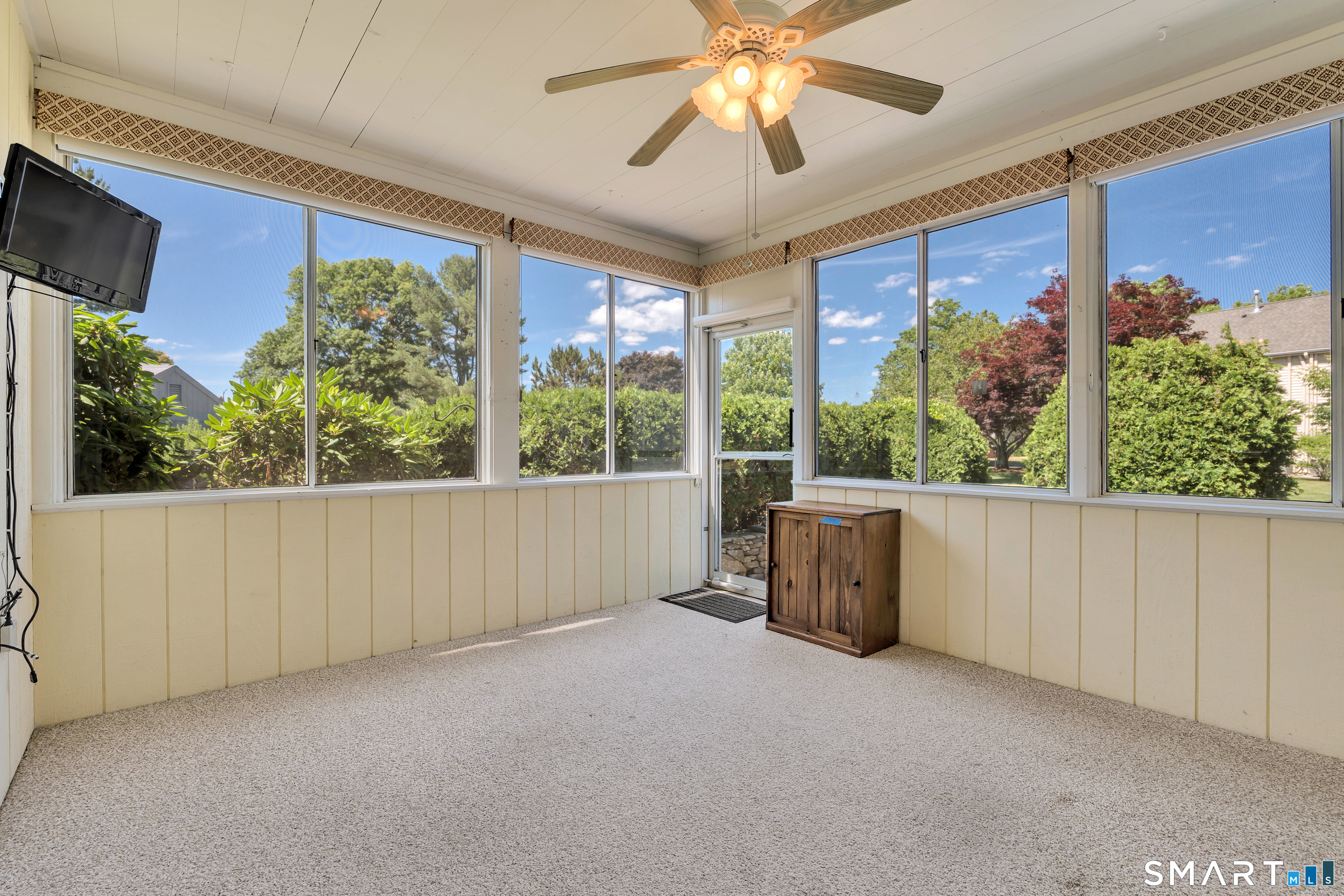 28 Downing Way, Unit 28 Madison, CT 06443 - Photo 19 of 30 Private 3 Season sunroom with tv. Opens to patio
